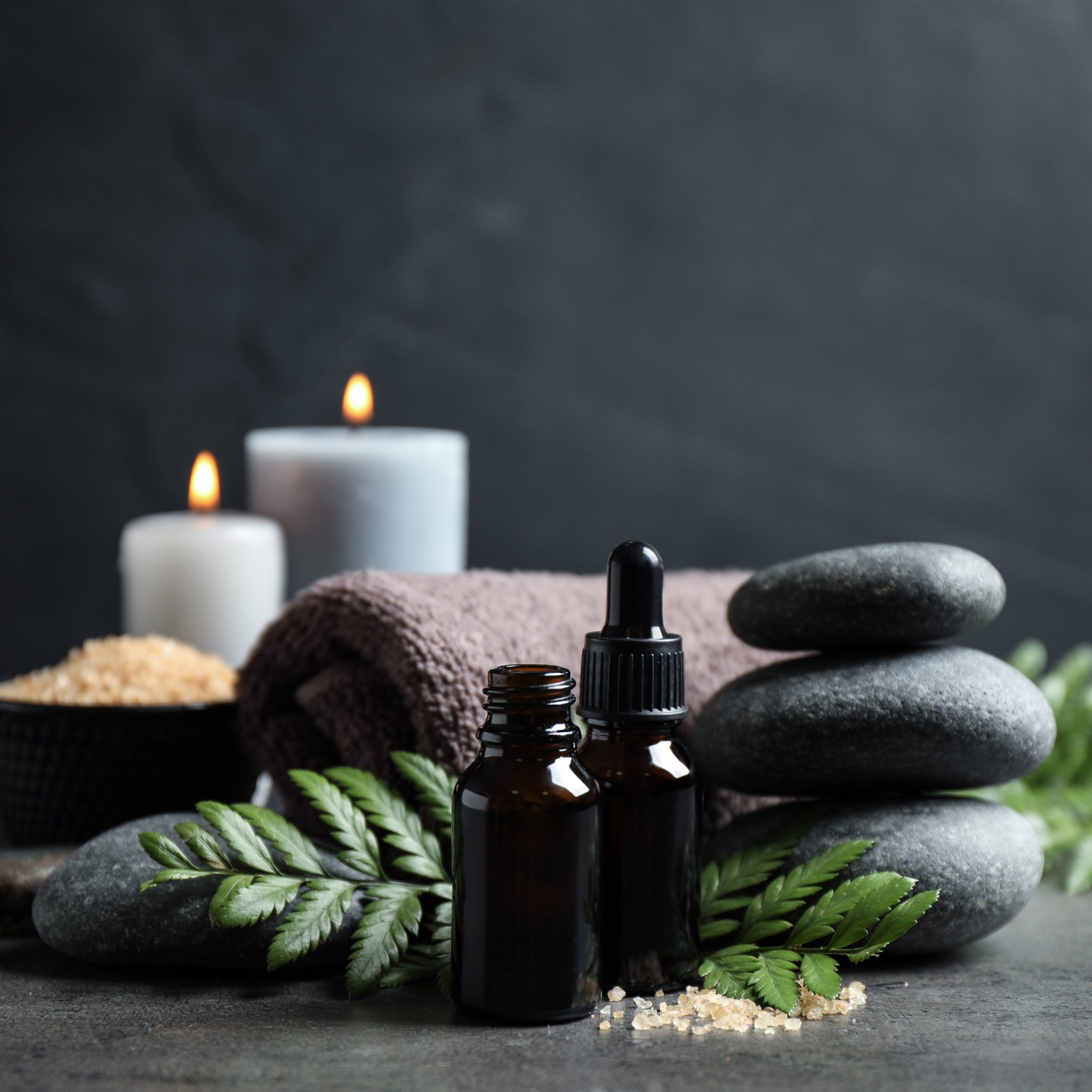 photo of beauty therapy equipment, candles, towels, oils, hot stones