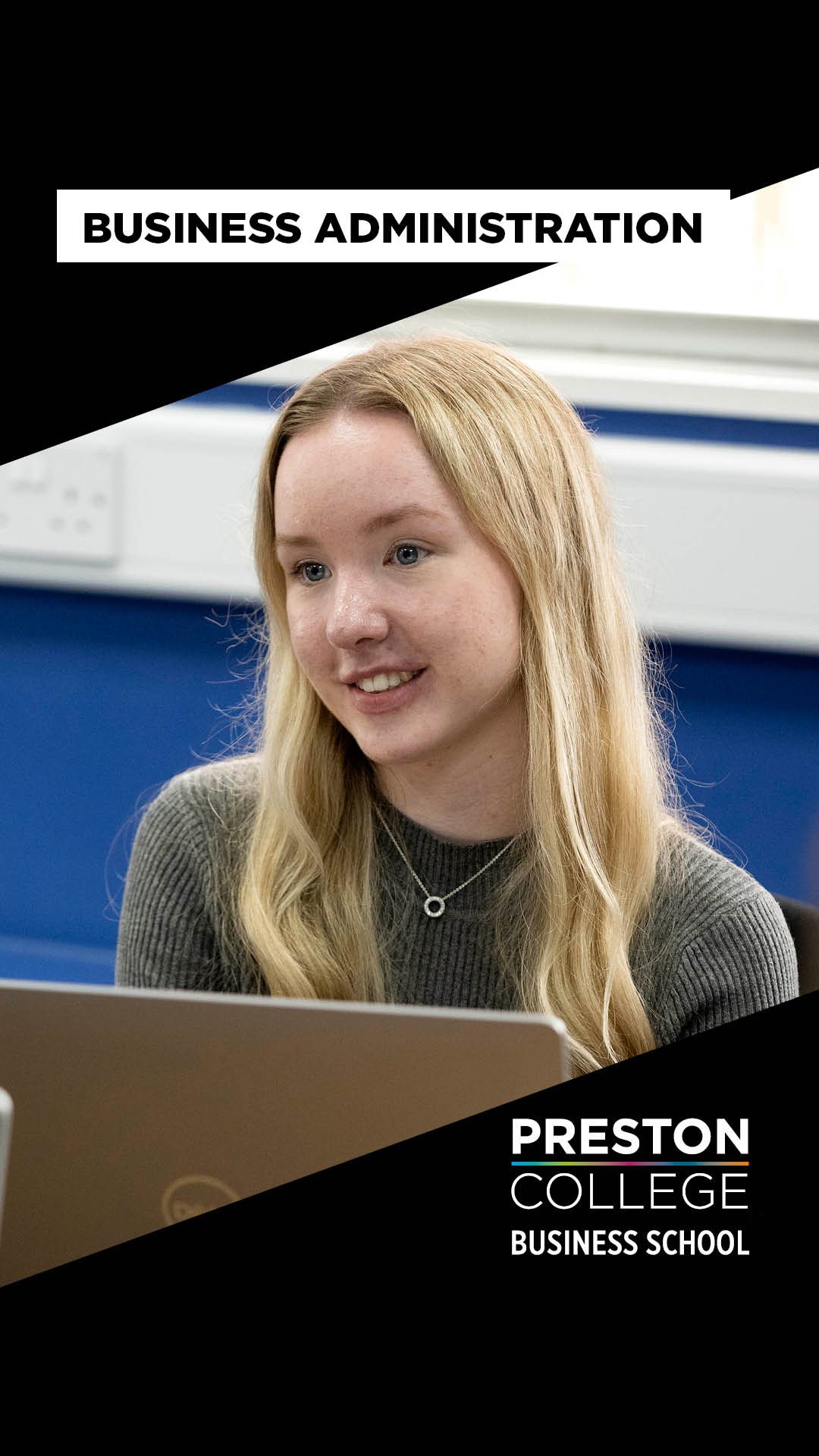 Girl with blond hair smiling looking at a computer