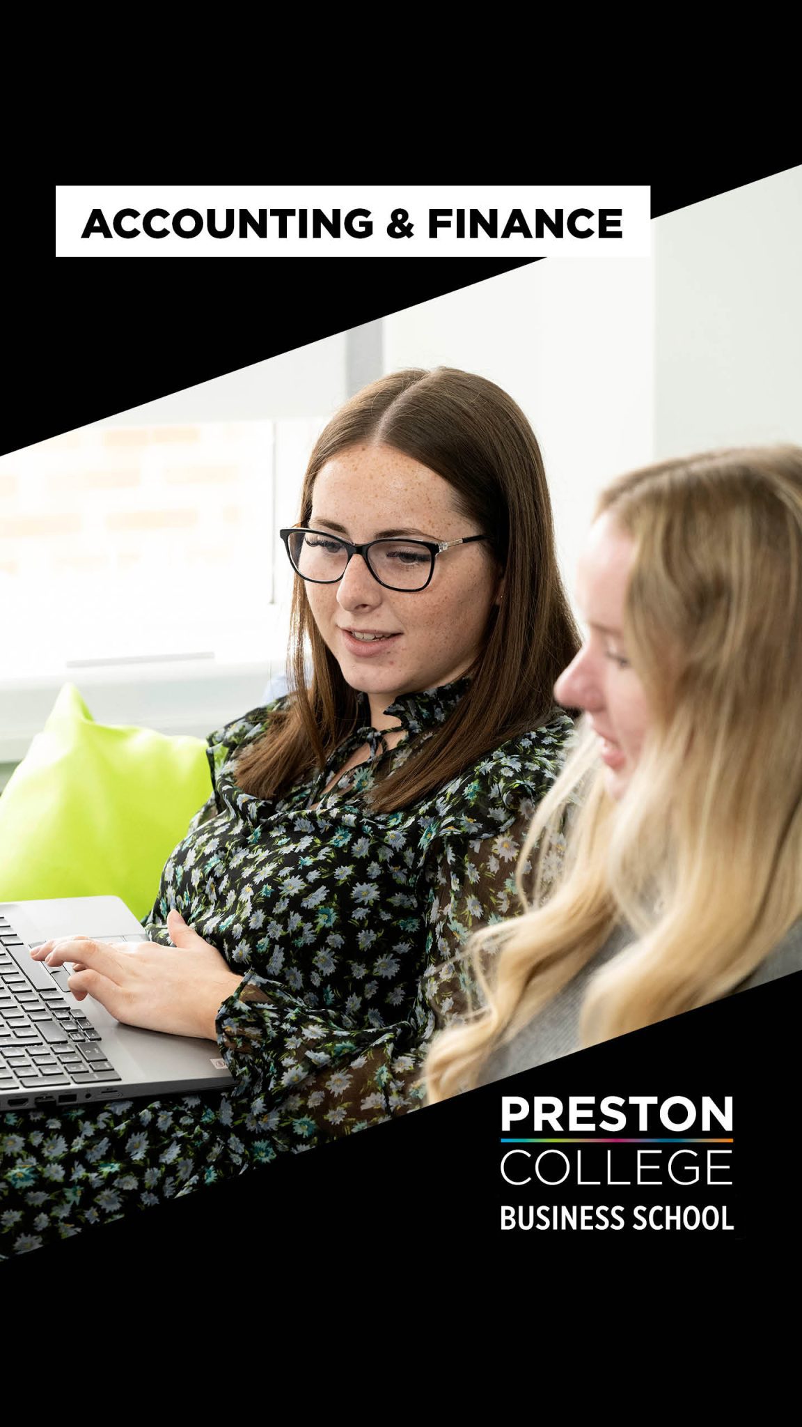 Two girls sat looking at a computer 