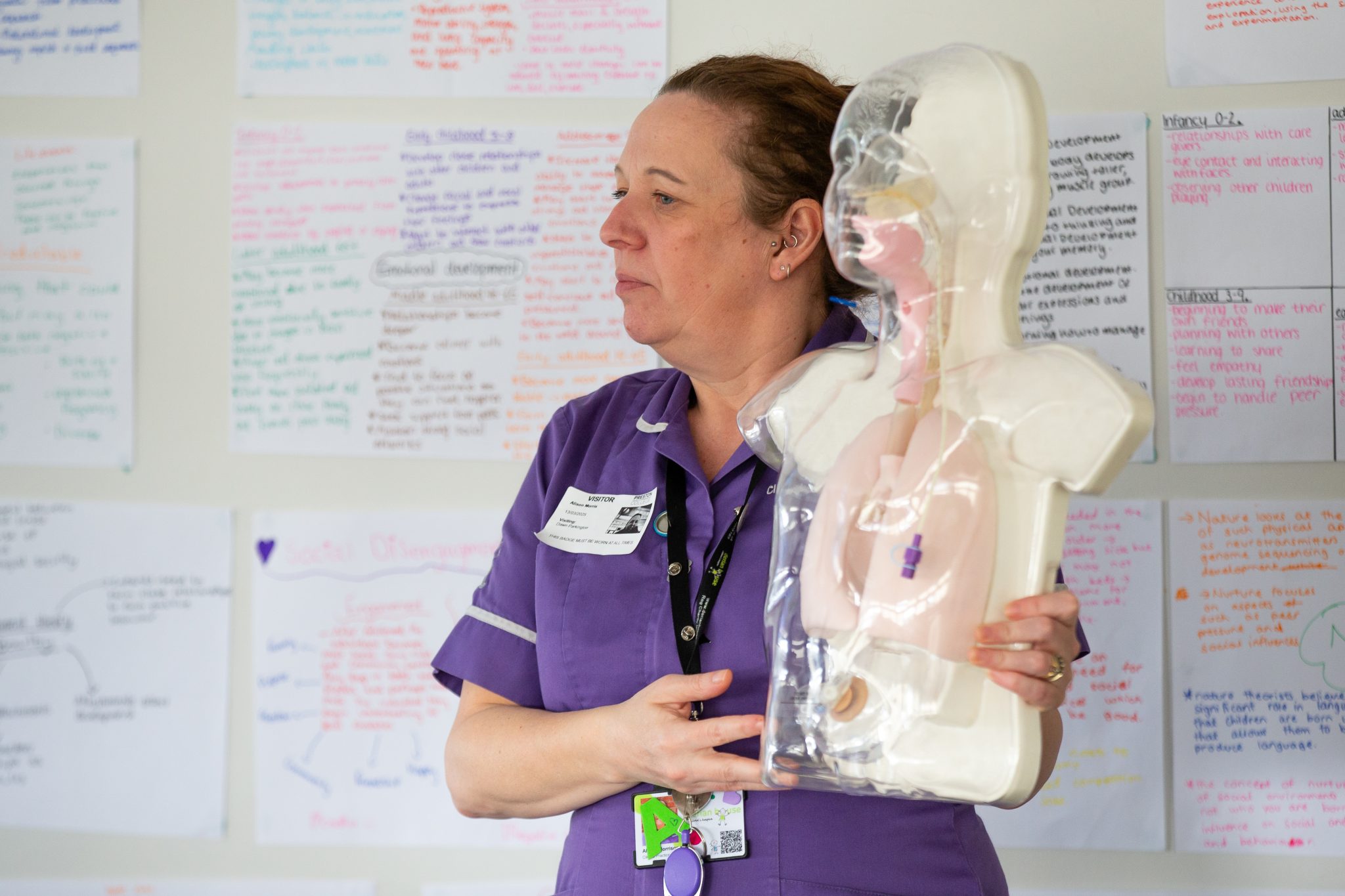 Child nurse from Derian House Hospice holding dummy model