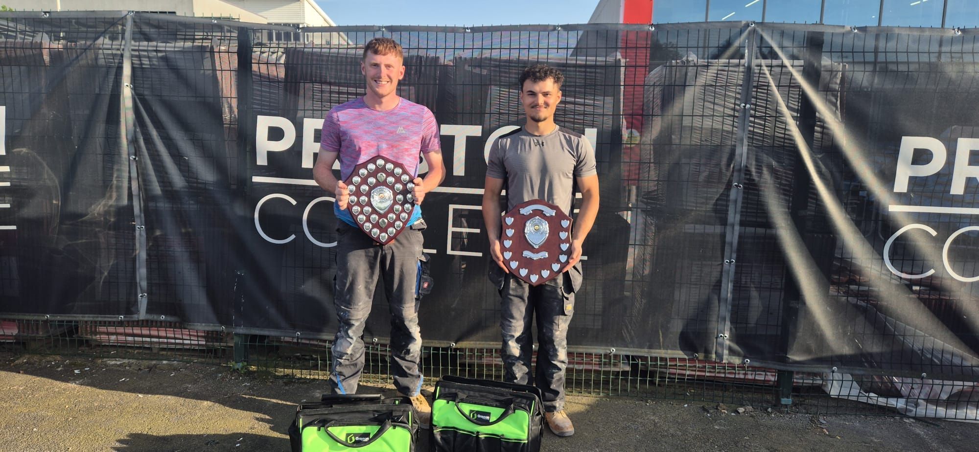 Apprentices stood with their trophies outside a construction site