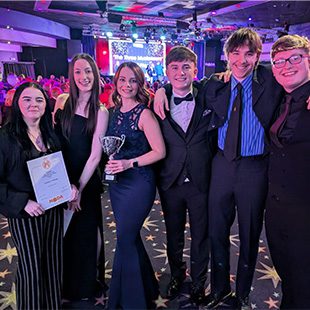 NODA winners holding certificate