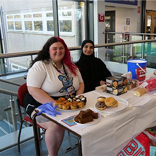 2 girls at cake stall