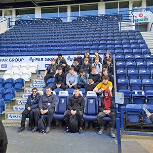 Students in football stadium
