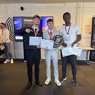 3 students holding award