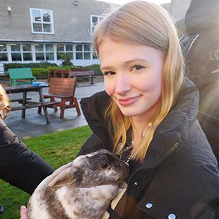 Student holding a bunny