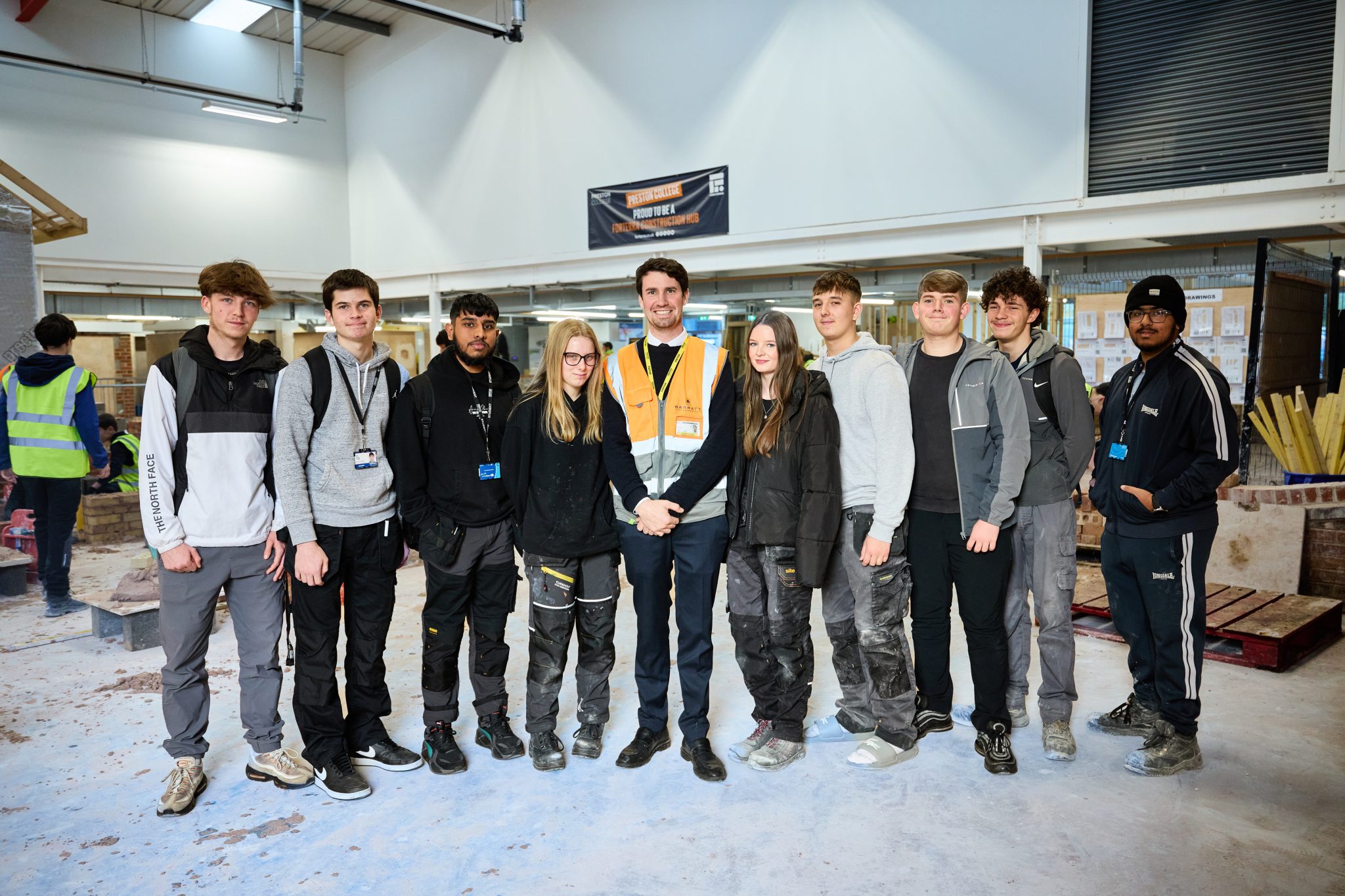 Preston College Student Ambassadors stand with Redrow Barratt Representative