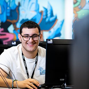Student sat at a computer room at Preston College